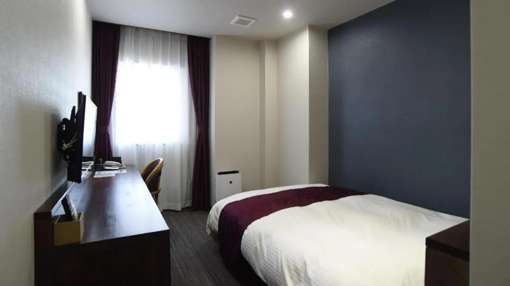 Bed in AKISAWA HOTEL