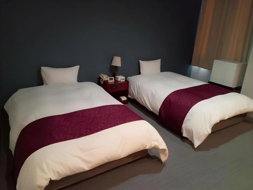 Bed in AKISAWA HOTEL