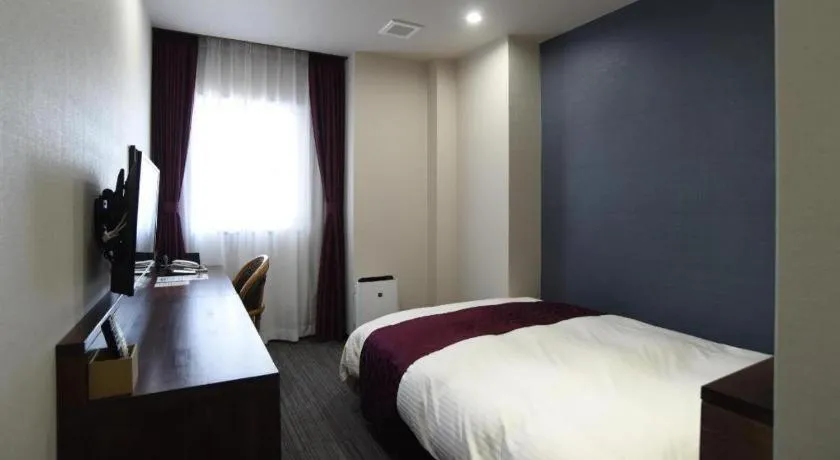 Bed in AKISAWA HOTEL