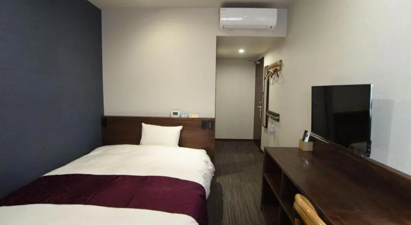 Bed in AKISAWA HOTEL