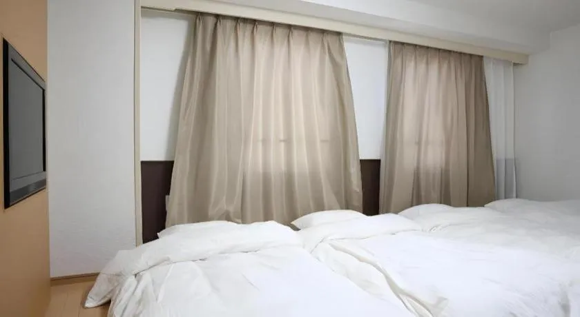 Bed in Hotel Sunshine Iwaki