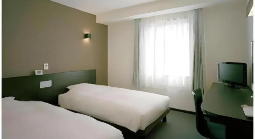 Bed in Hotel New Amami