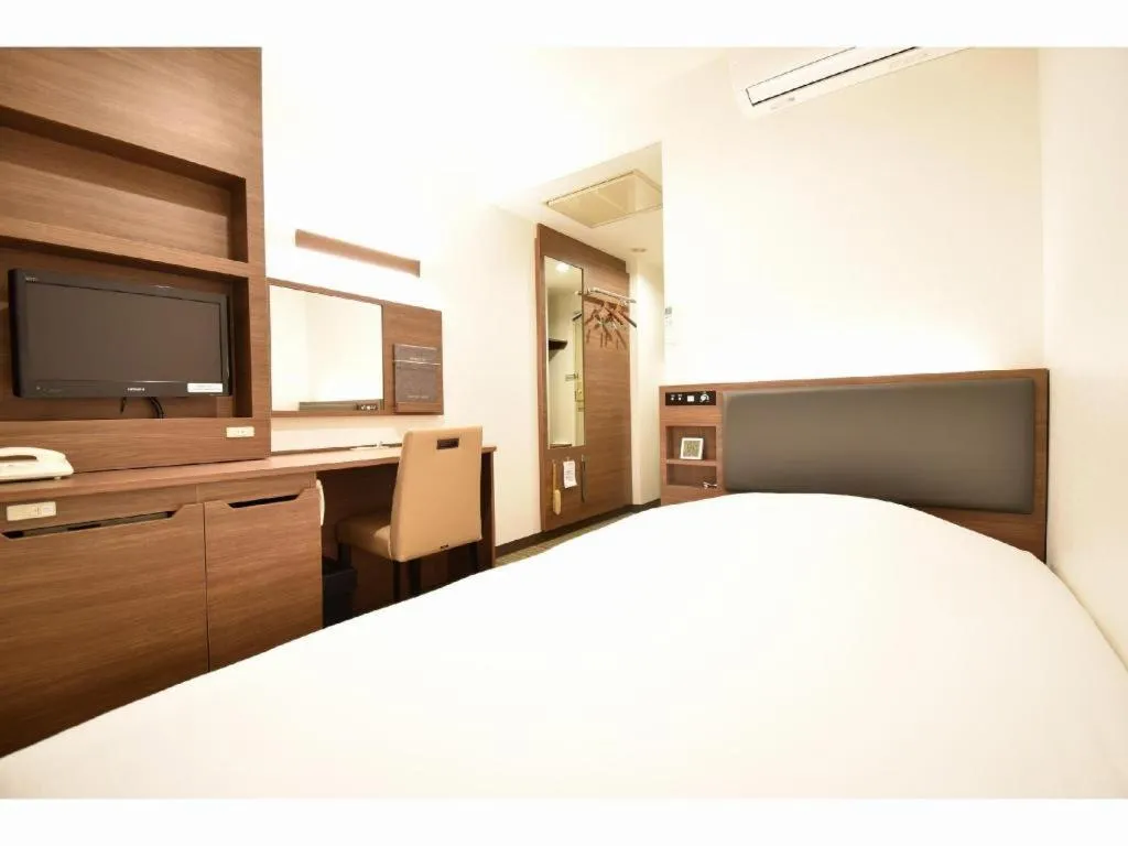 Bed in Hotel New Amami