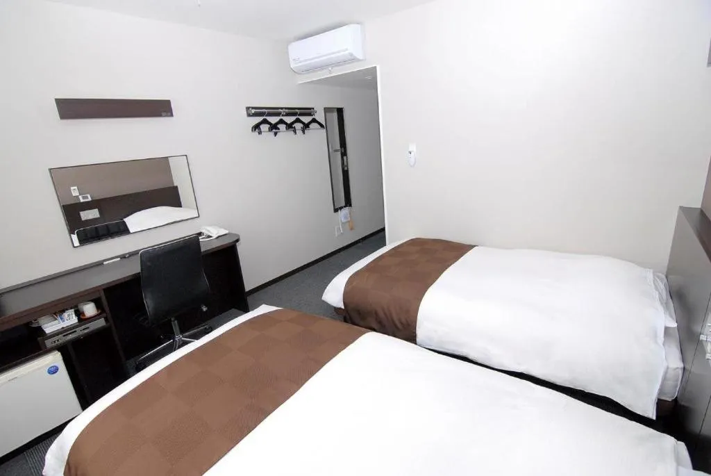 Bed in Hotel New Amami