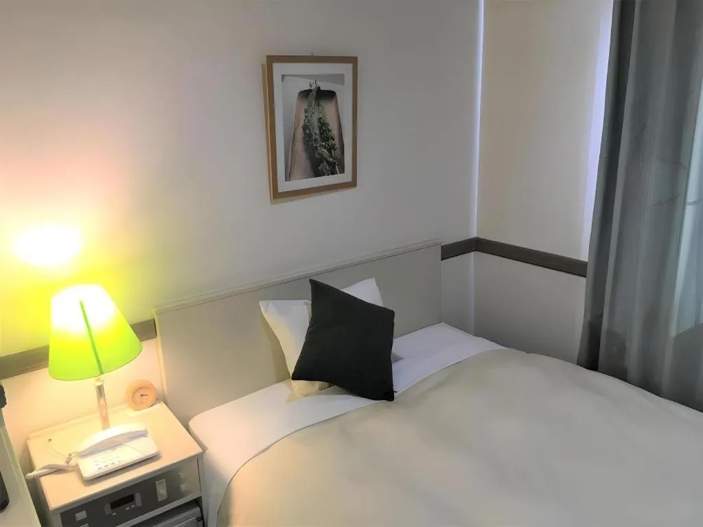 Bed in Matsumoto Wellton Hotel