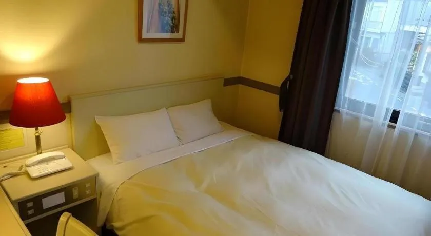 Bed in Matsumoto Wellton Hotel