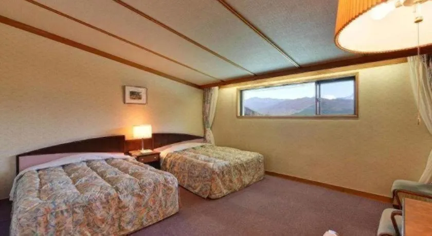 Bed in Oze Iwakura Resort Hotel