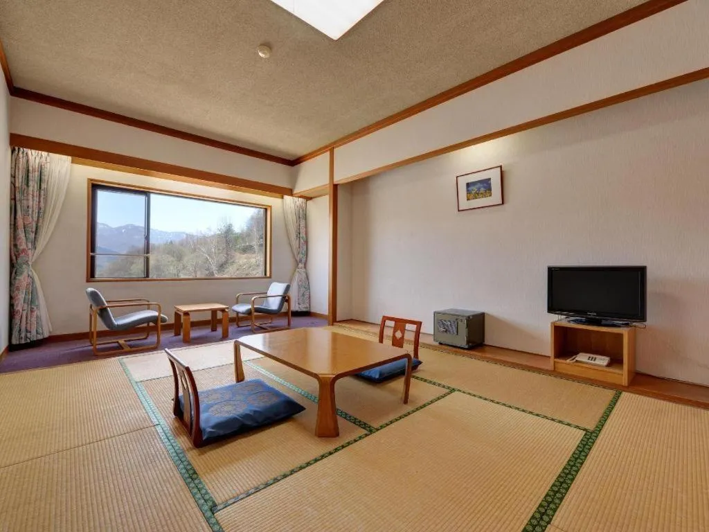 Bed in Oze Iwakura Resort Hotel