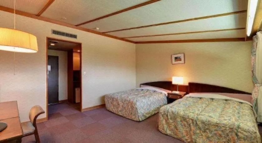 Bed in Oze Iwakura Resort Hotel