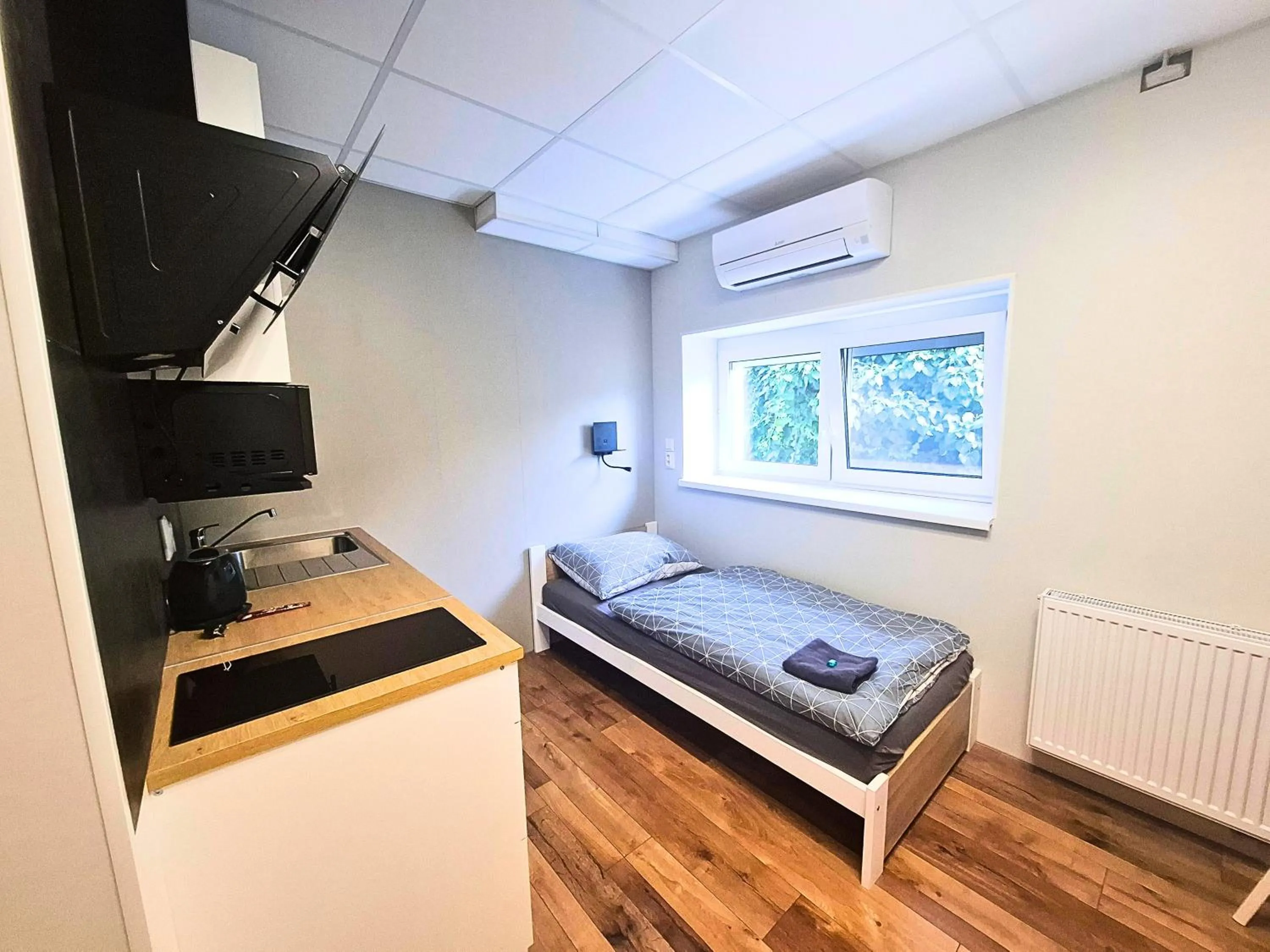 Kitchen or kitchenette, Bed in Dimael Hostel & Apartments