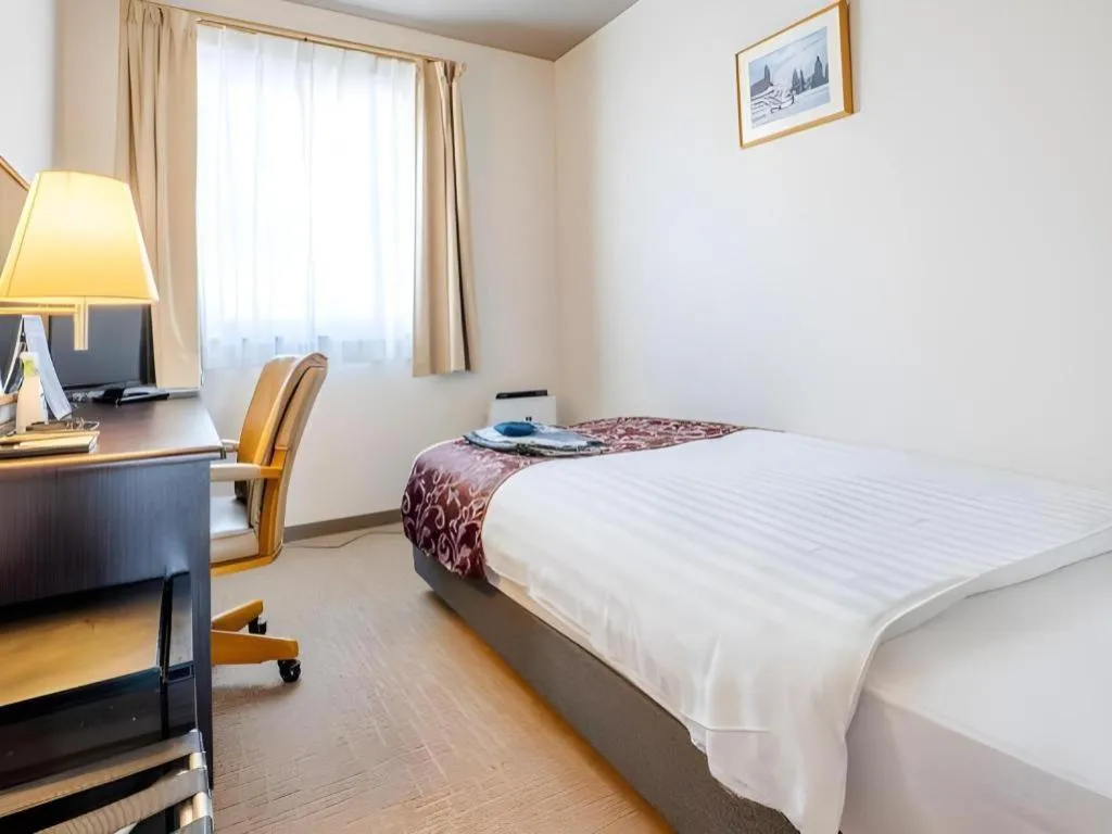 Bed in Kamisuwa Station Hotel