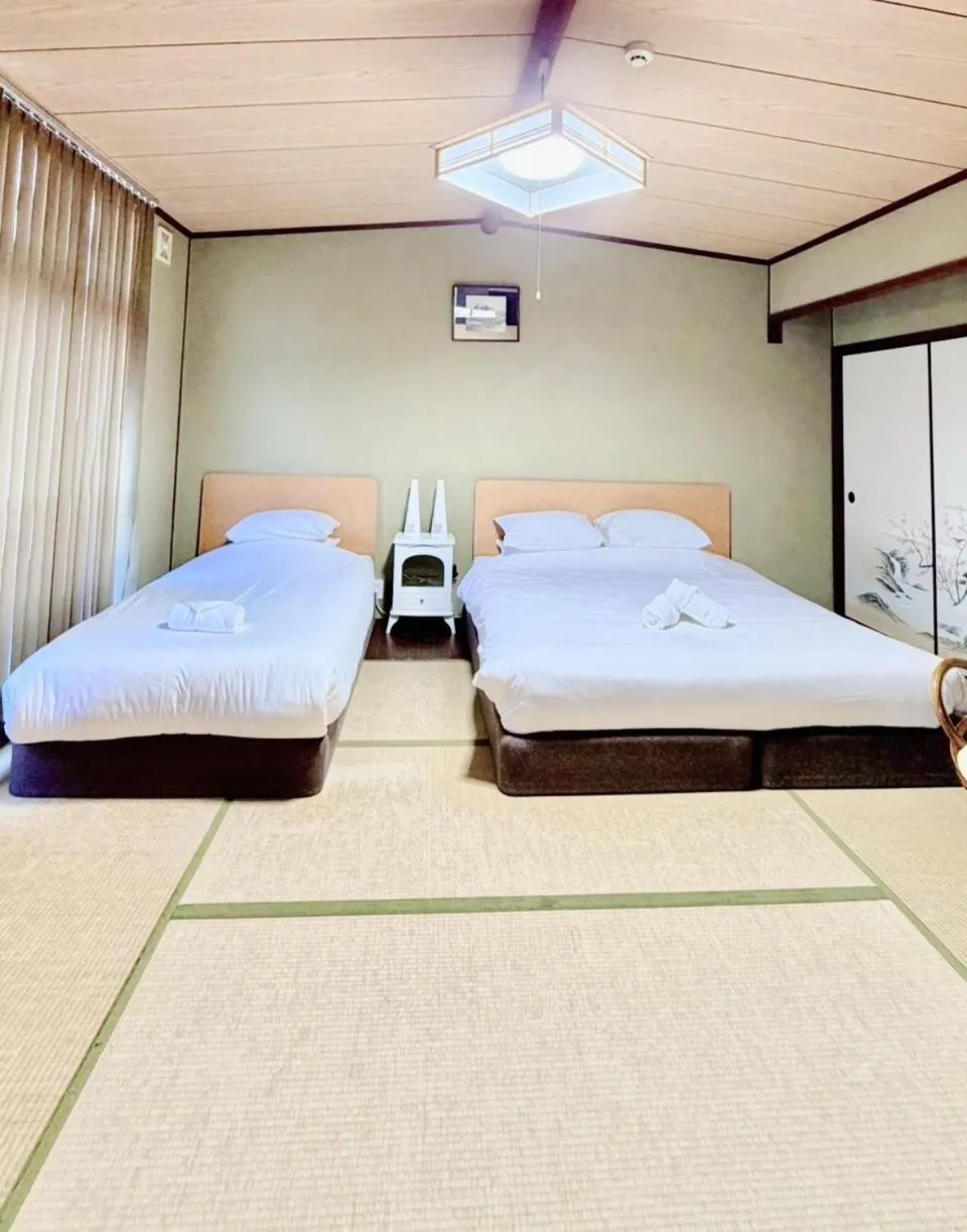 Bed in Tabist International Hotel Kaike