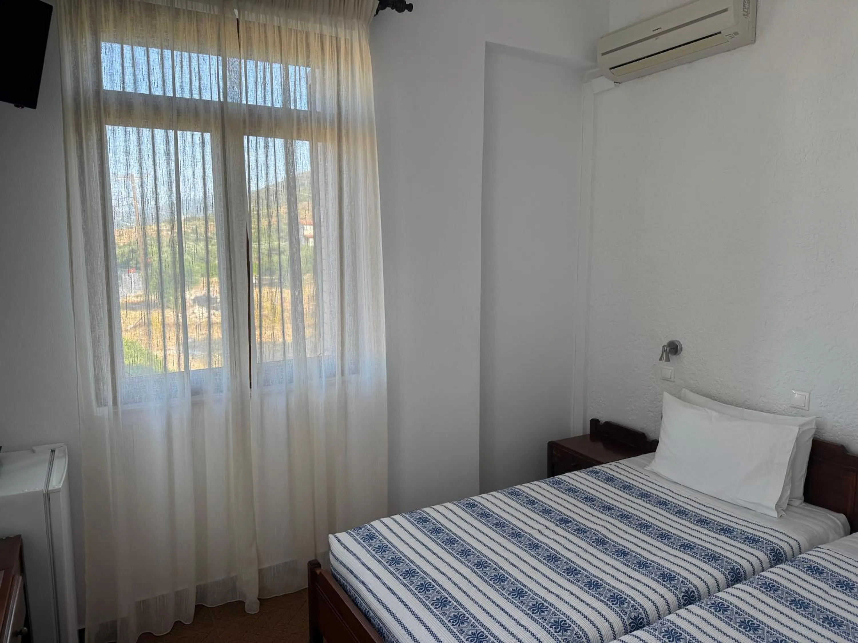 Bed in Pythaïs Hotel