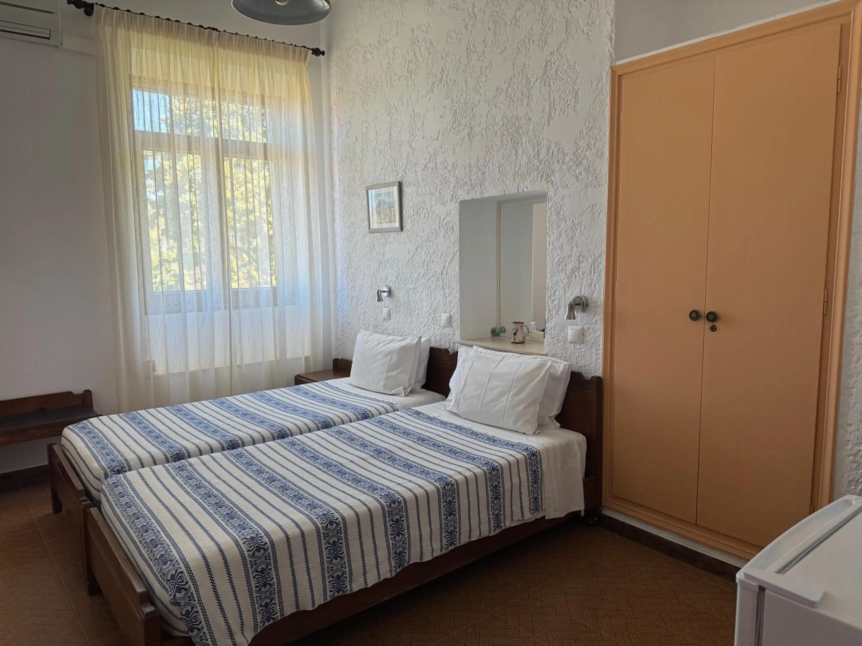 Bed in Pythaïs Hotel