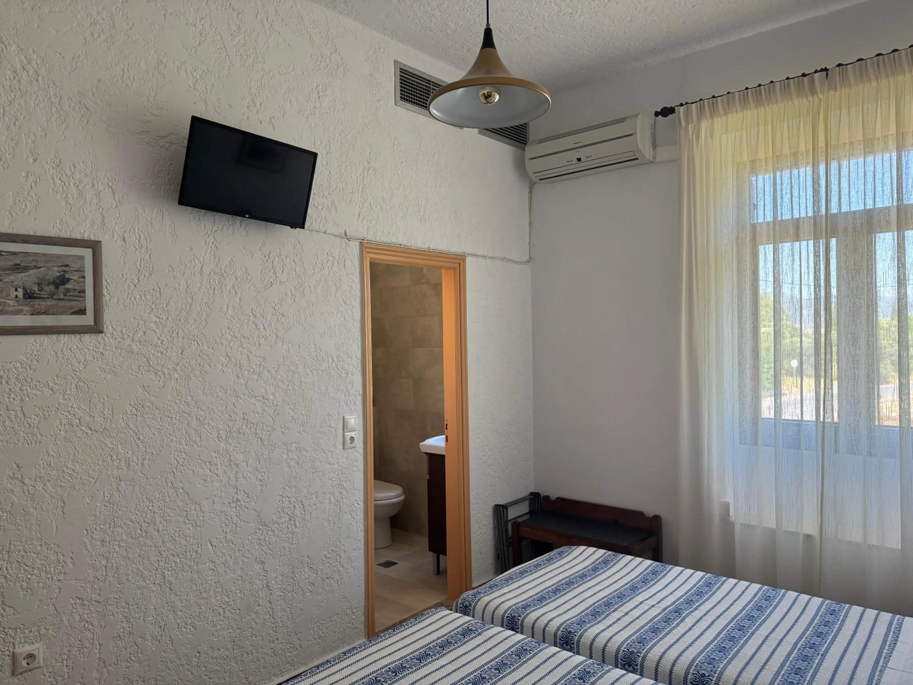 Bed in Pythaïs Hotel