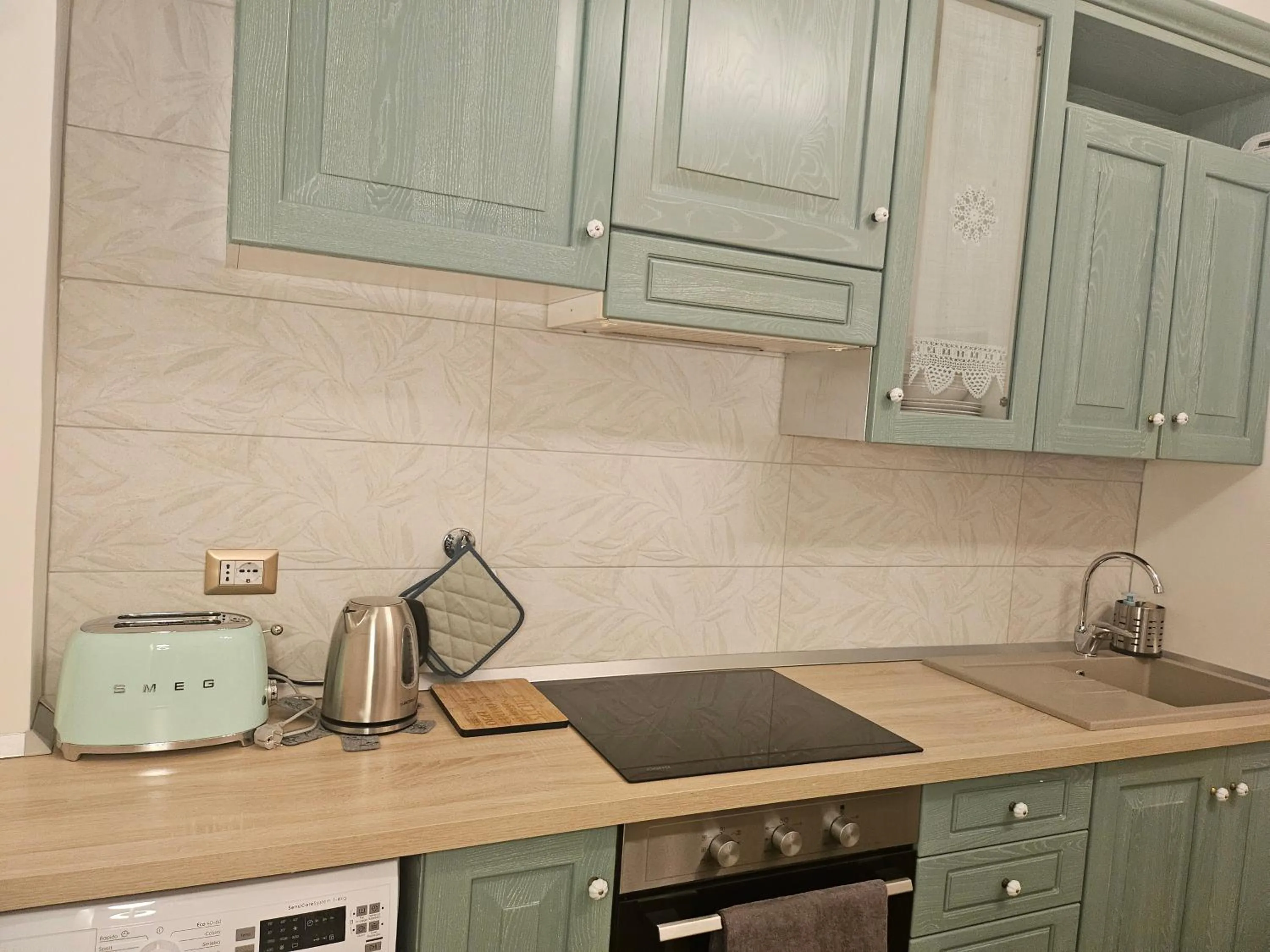 Kitchen or kitchenette in Merulana Suite Apartment