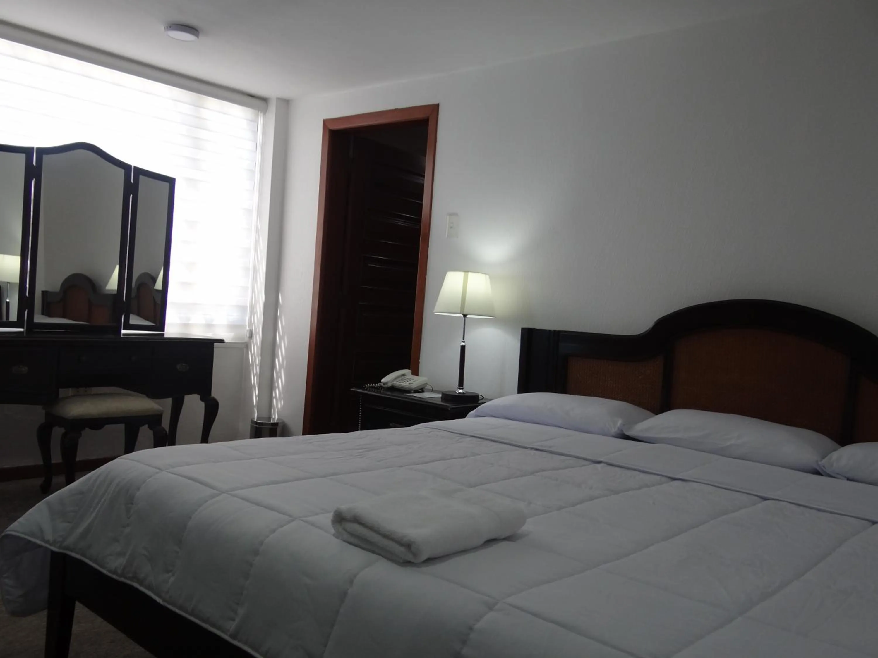 Bed in Altura Rooms & Suites