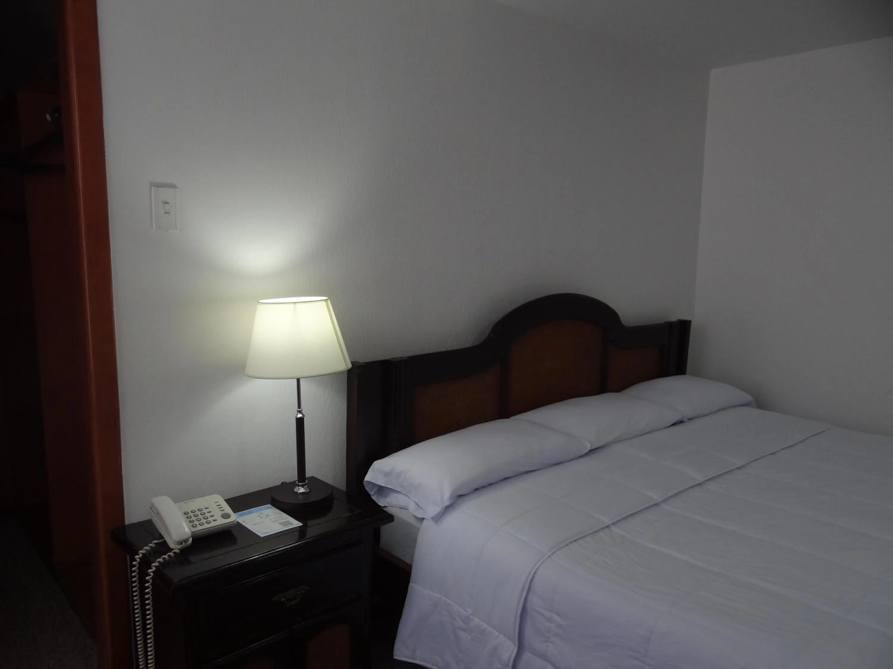 Bed in Altura Rooms & Suites