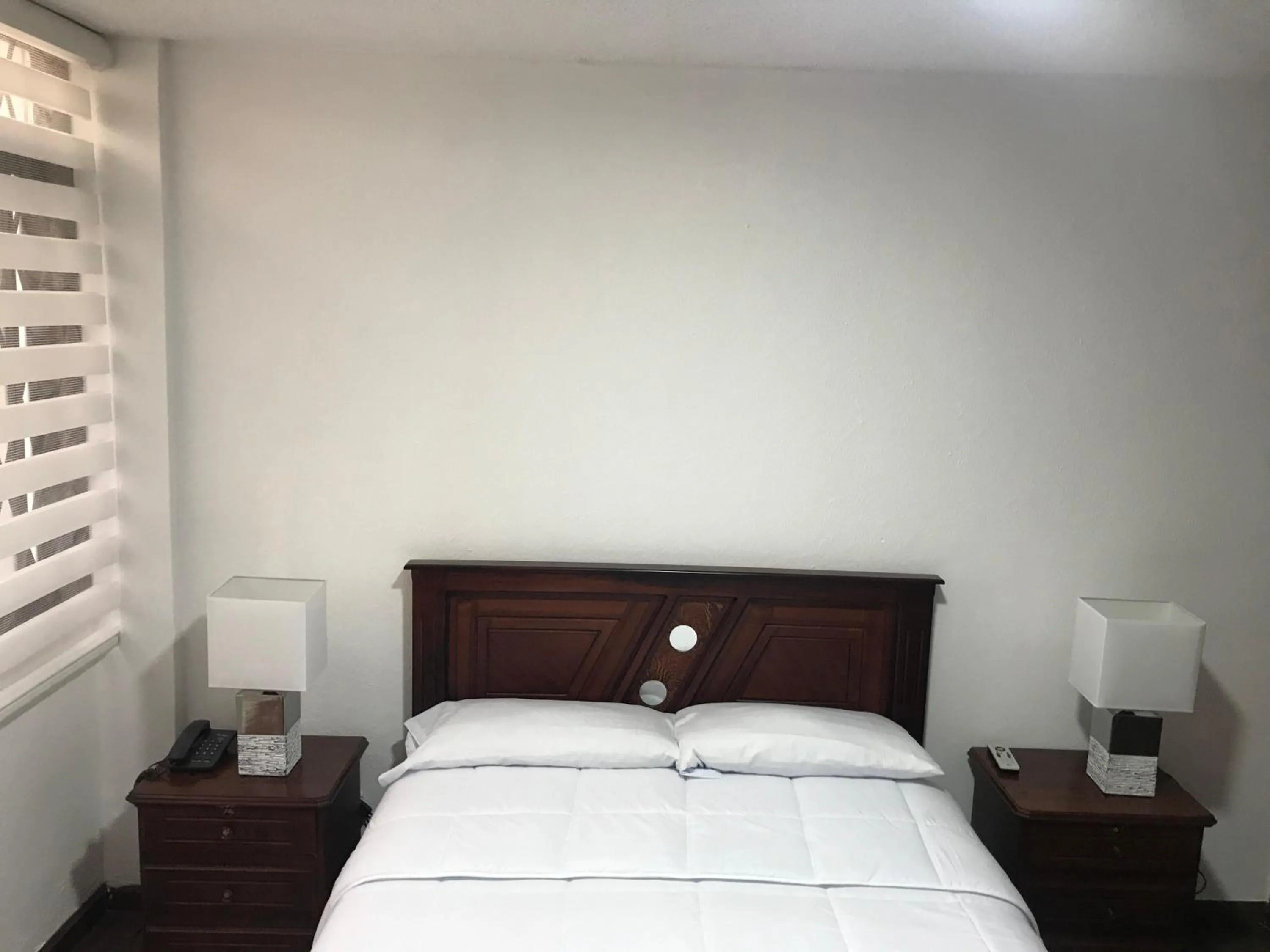 Bed in Altura Rooms & Suites