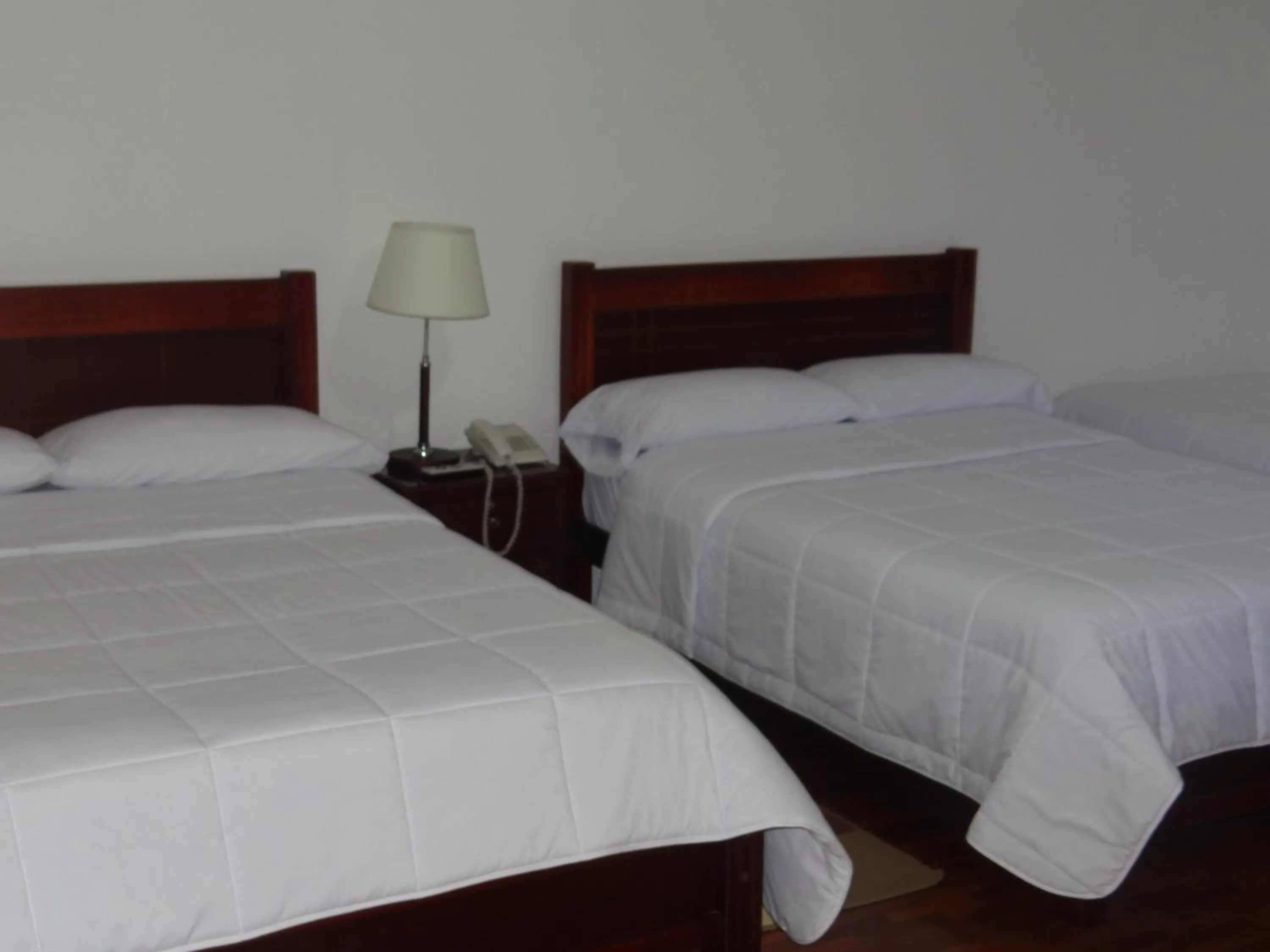 Bed in Altura Rooms & Suites