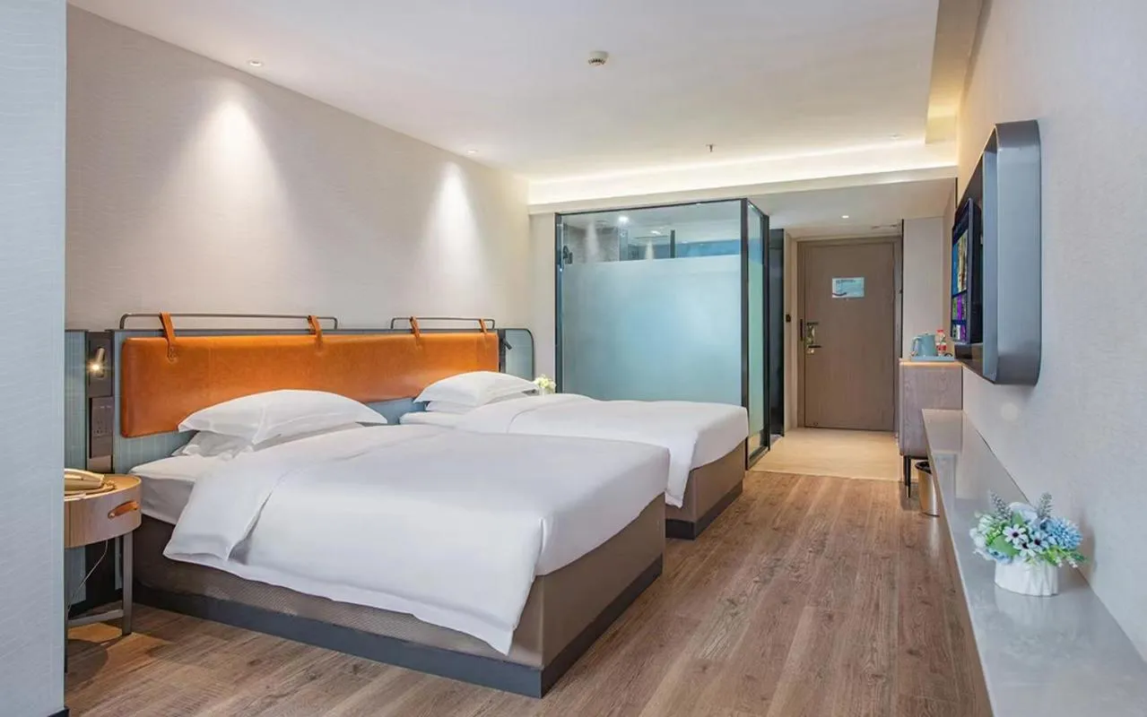 Bed in Echarm Hotel Guangzhou Jiahe Helong Branch