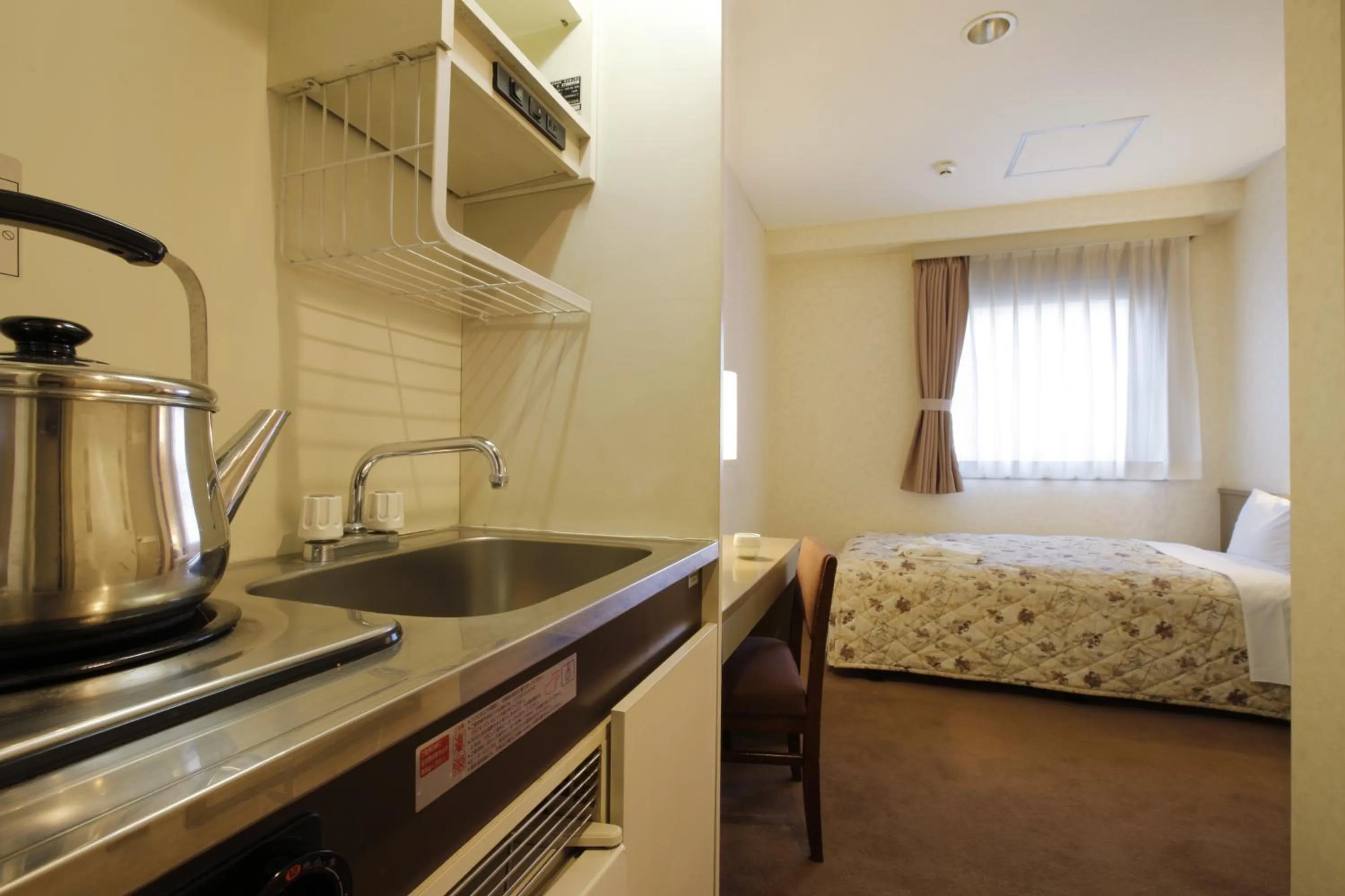 Kitchen or kitchenette, Bed in Sankei City Hotel Chiba