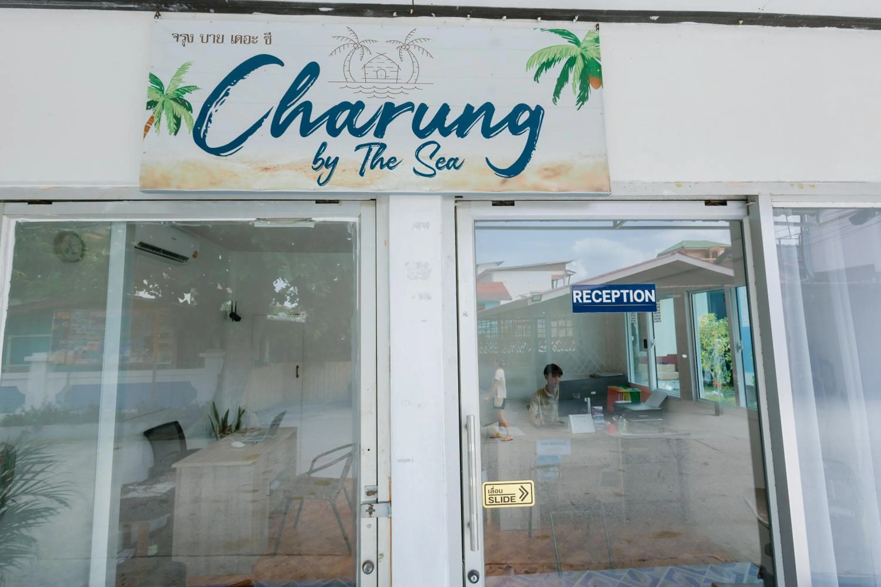 Property logo or sign in Charung by The Sea
