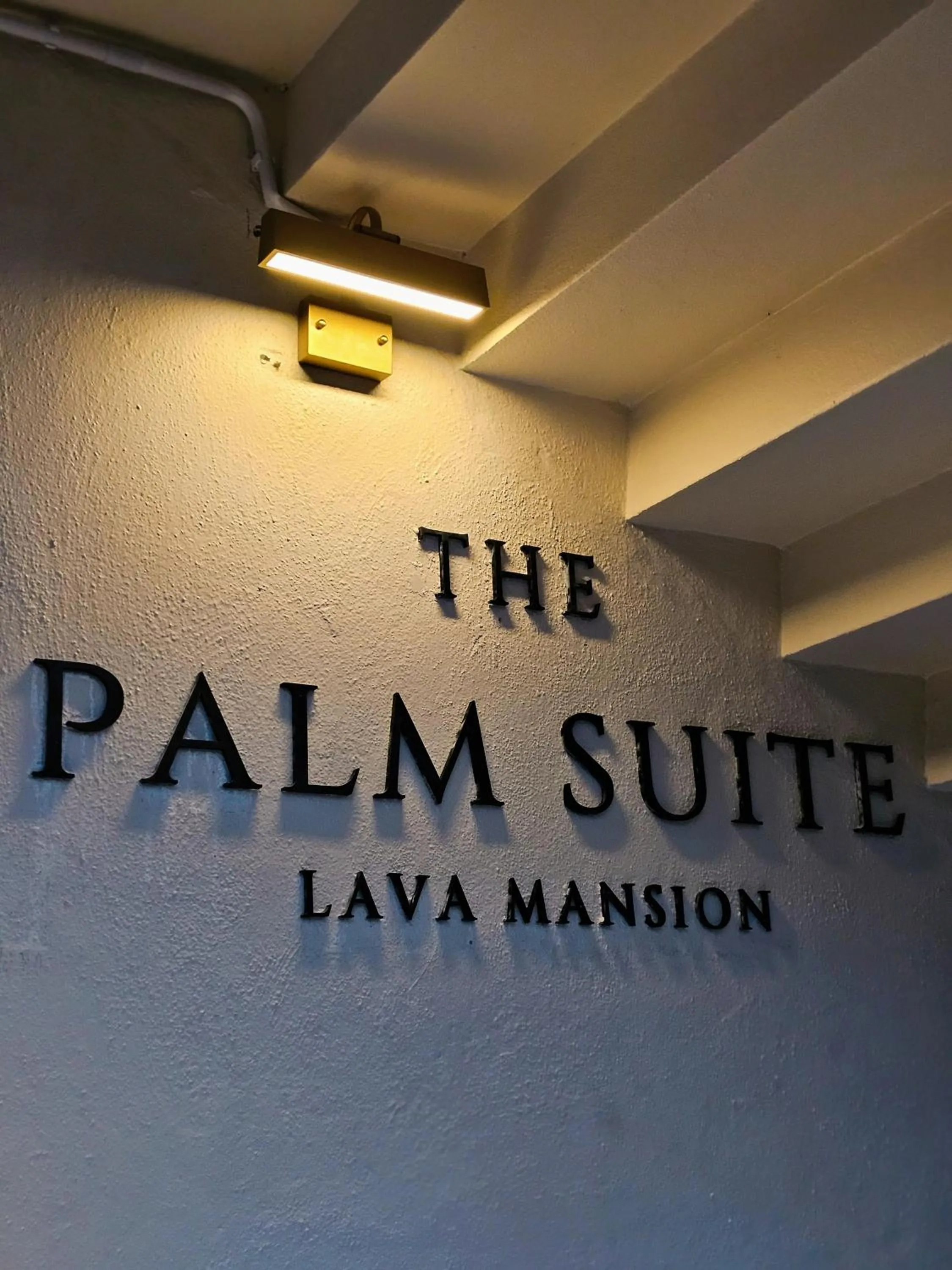 Property logo or sign in The Palm Suite at Lava Mansion