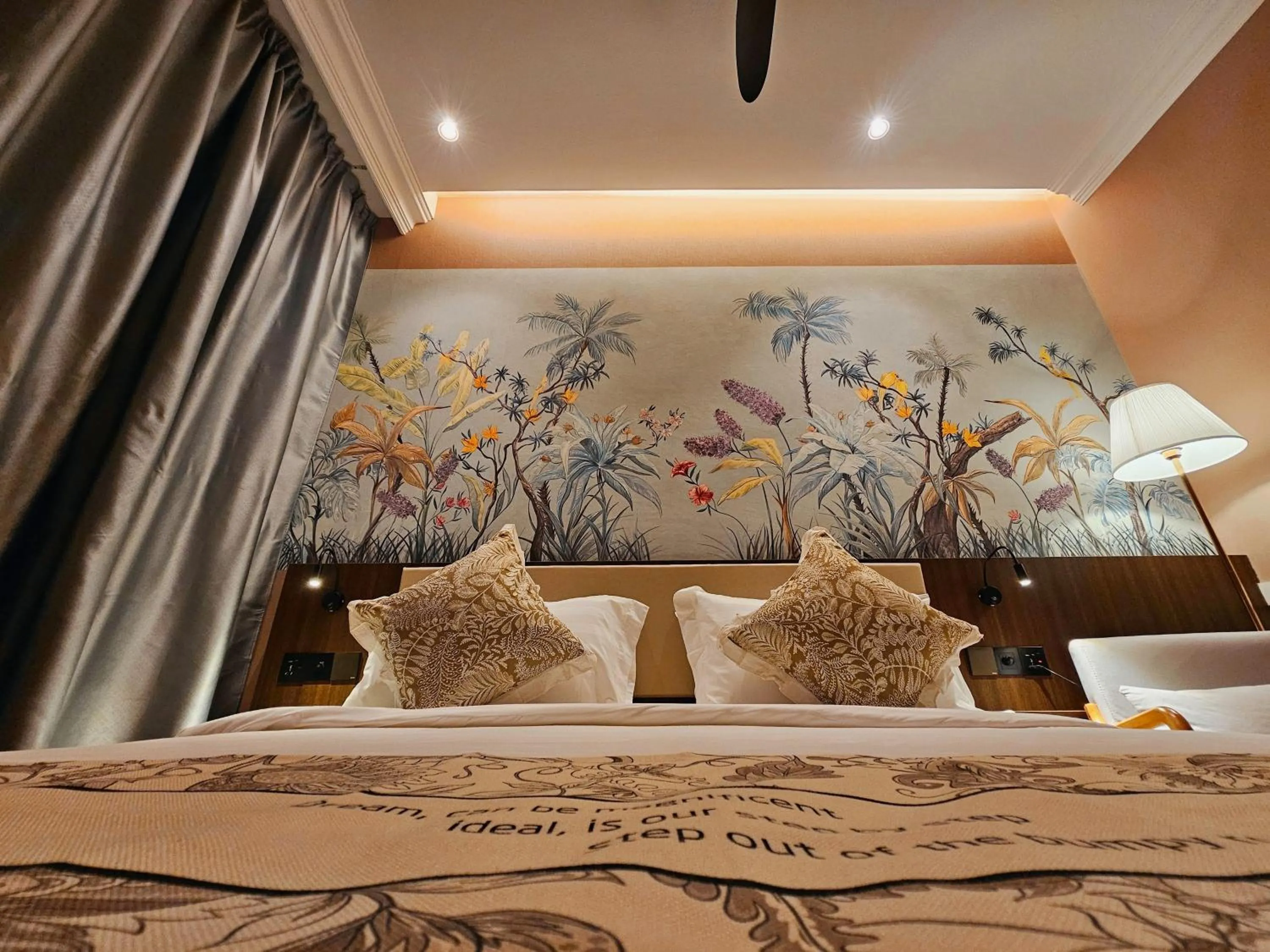 Bed in The Palm Suite at Lava Mansion