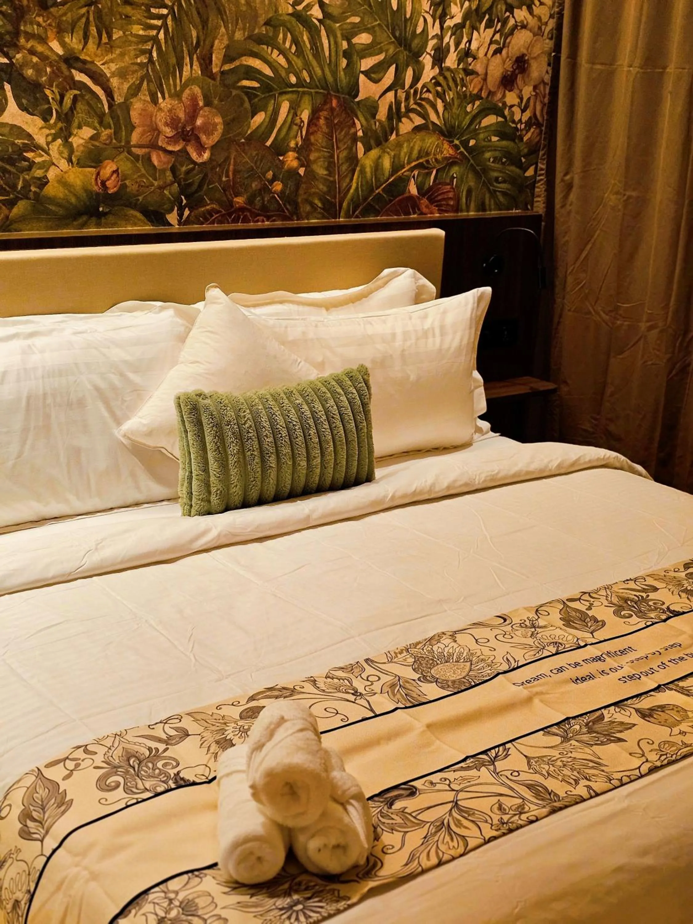 Bed in The Palm Suite at Lava Mansion