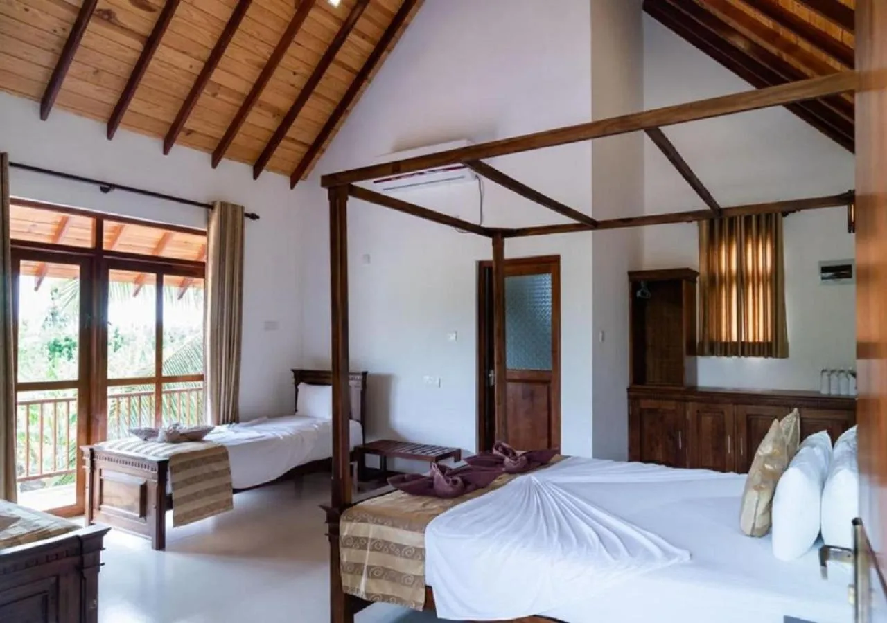 Bed in The Coconut Gardens Hotel & Restaurant