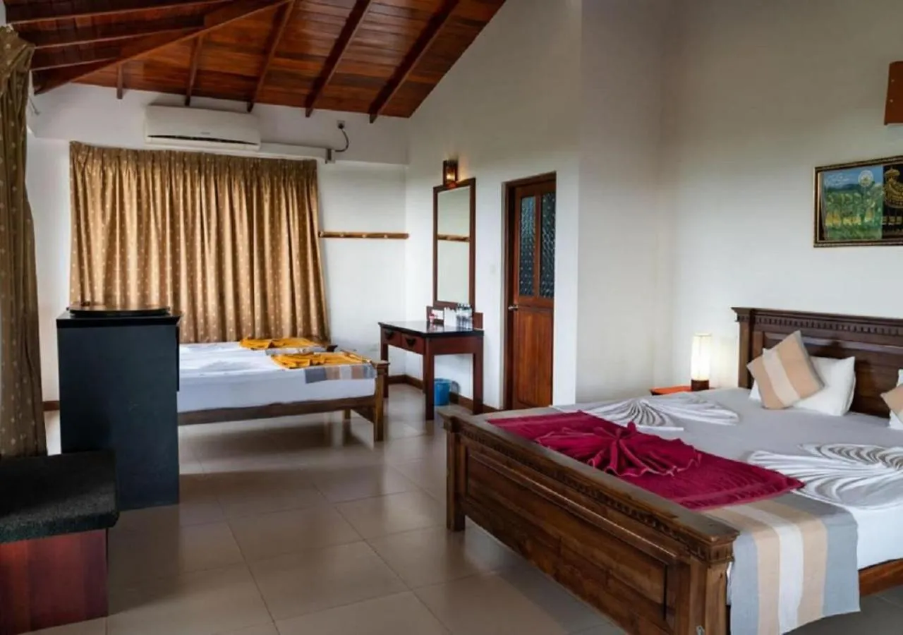 Bed in The Coconut Gardens Hotel & Restaurant
