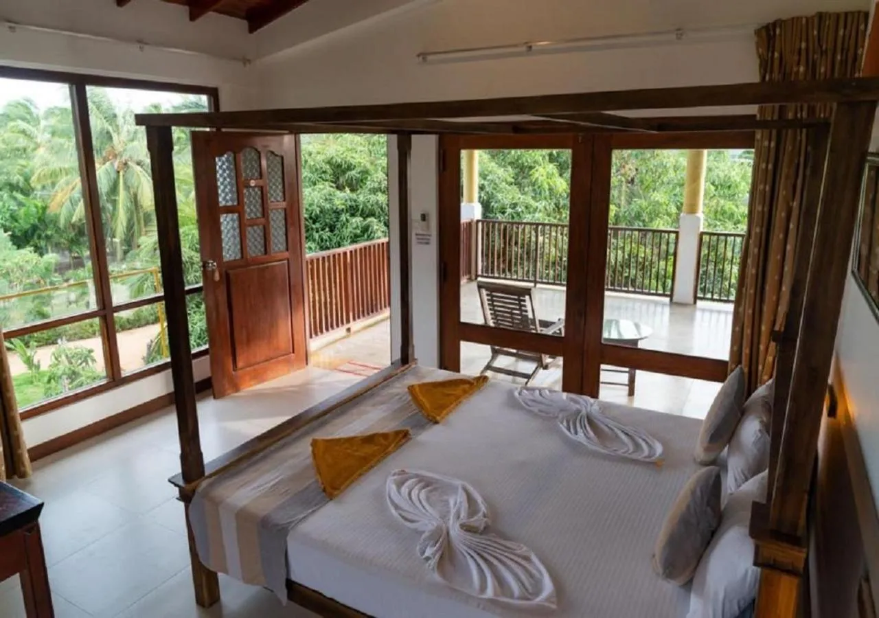 Bed in The Coconut Gardens Hotel & Restaurant
