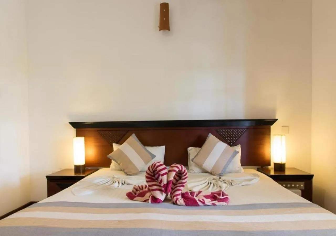 Bed in The Coconut Gardens Hotel & Restaurant