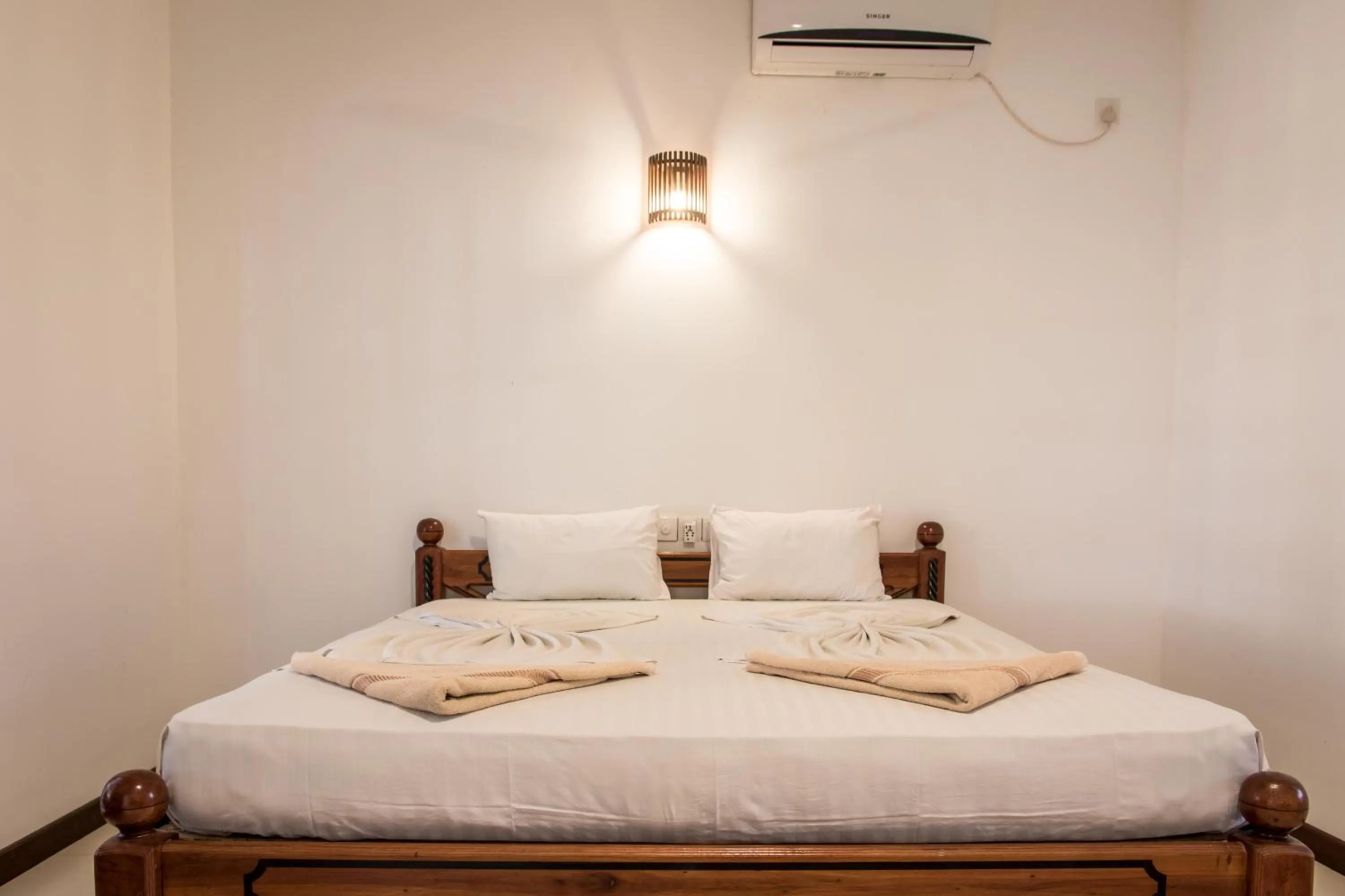 Bed in The Coconut Gardens Hotel & Restaurant