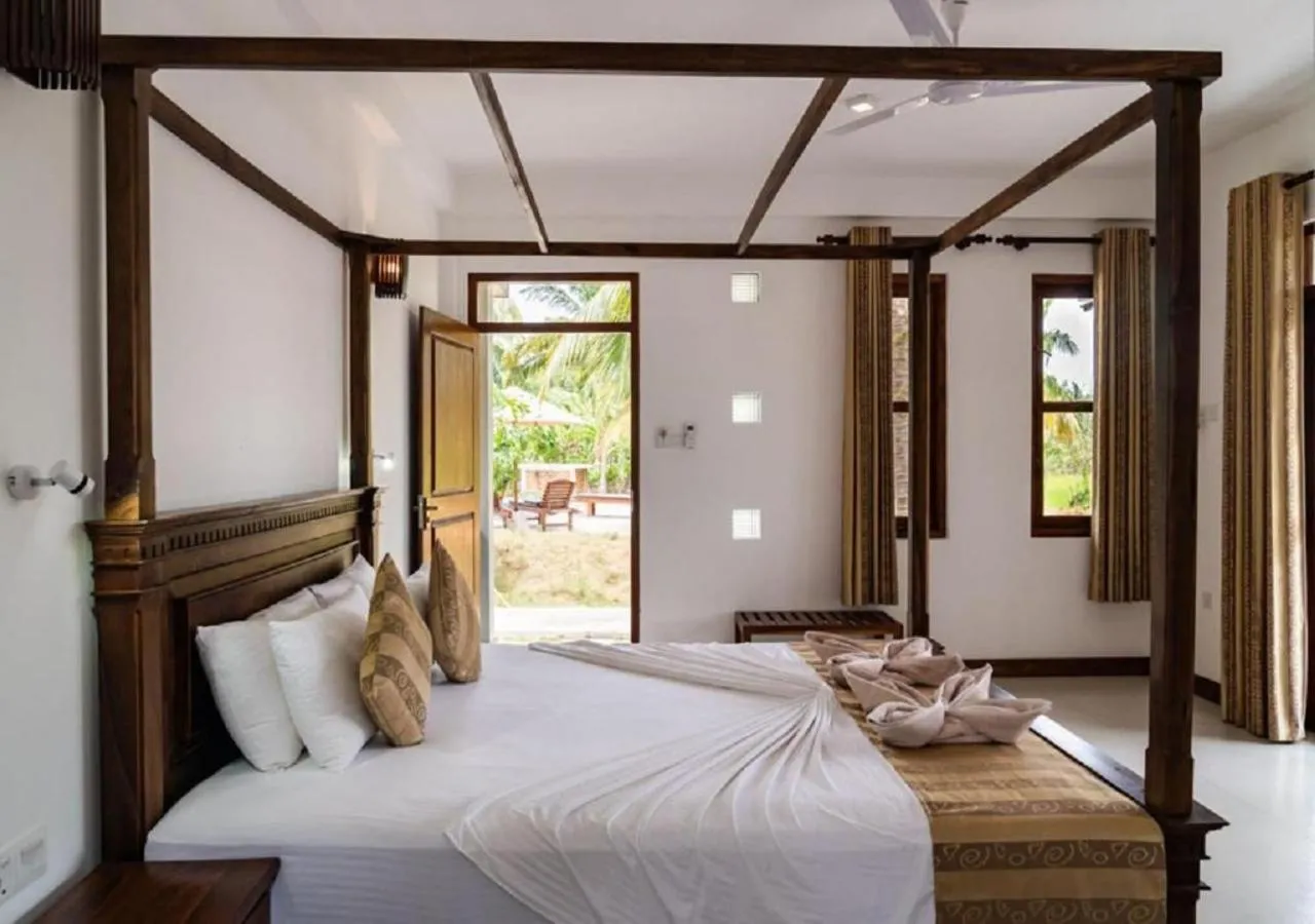 Bed in The Coconut Gardens Hotel & Restaurant