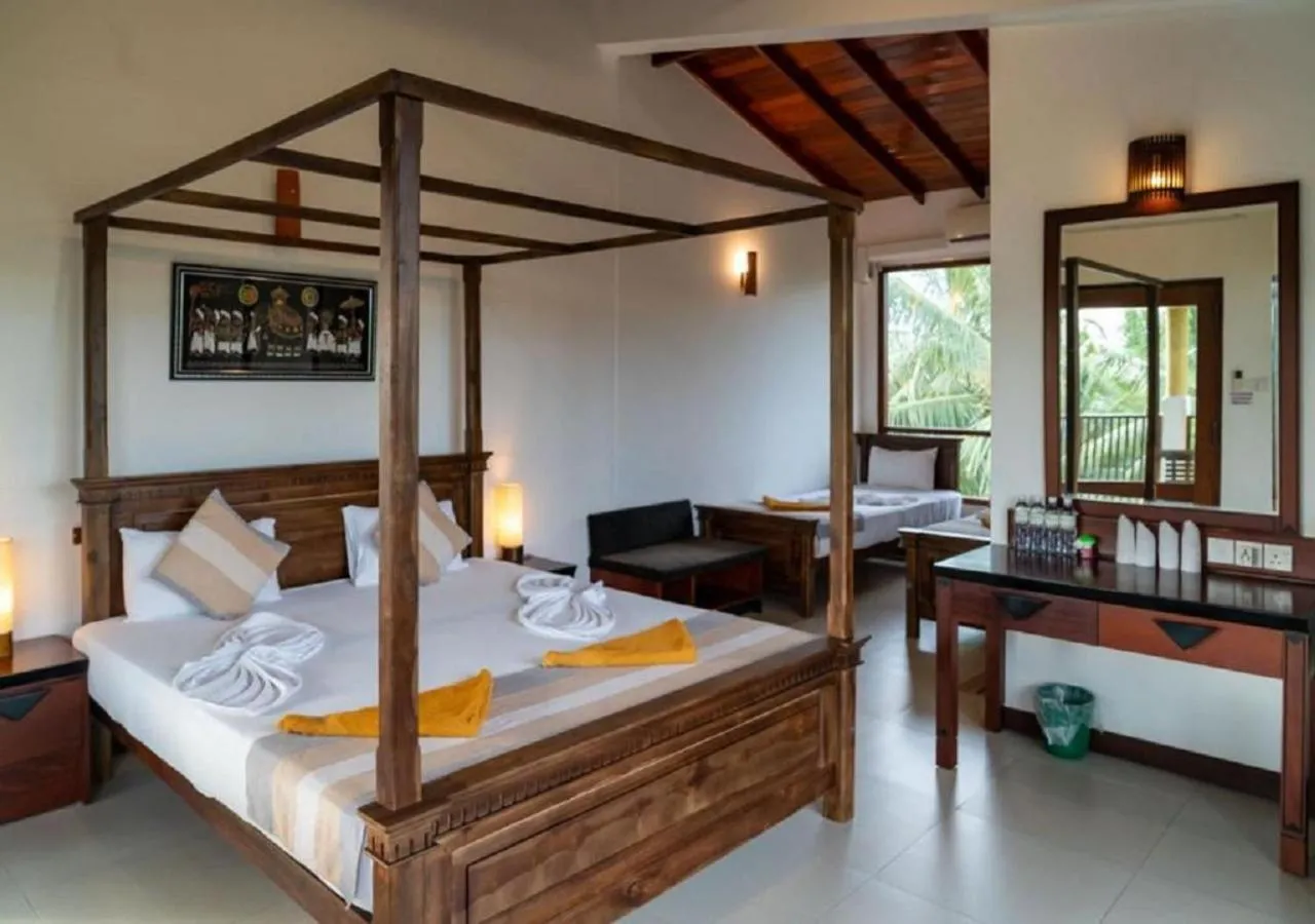 Bed in The Coconut Gardens Hotel & Restaurant