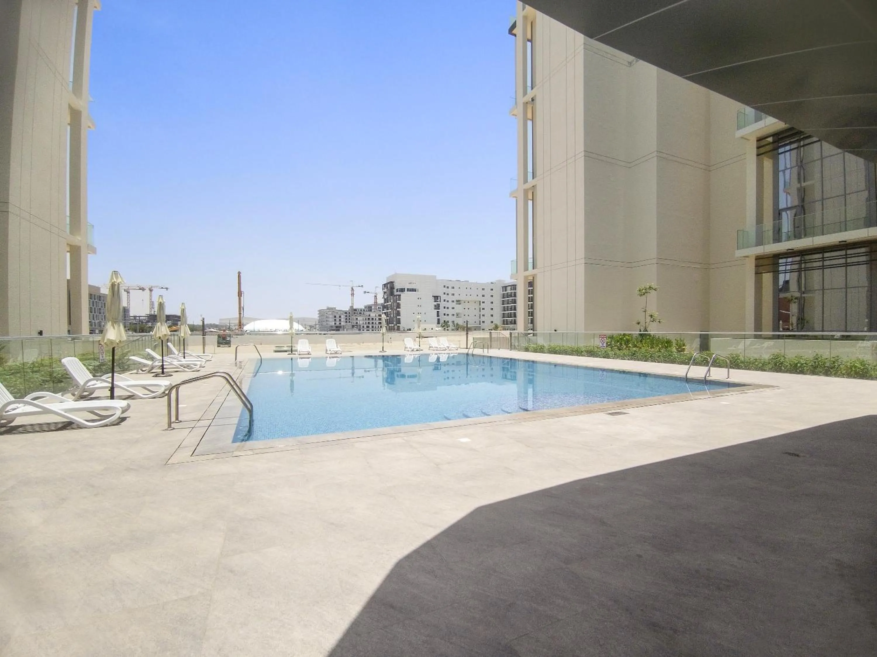 Swimming pool in Silkhaus Vacation Homes Modern 1BDR in Oasis Near Masdar City Park