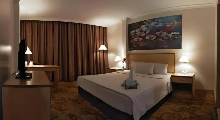 Bed in The Orchid Hotel Bed in The Orchid Hotel