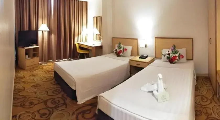 Bed in The Orchid Hotel Bed in The Orchid Hotel