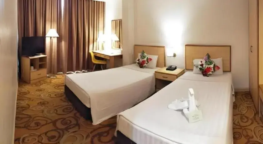 Bed in The Orchid Hotel Bed in The Orchid Hotel