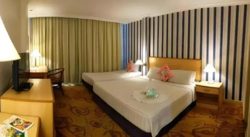 Bed in The Orchid Hotel Bed in The Orchid Hotel