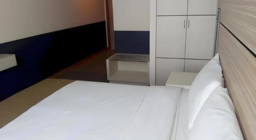 Bed in Grand Medallion Hotel