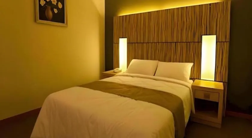 Bed in Grand Medallion Hotel