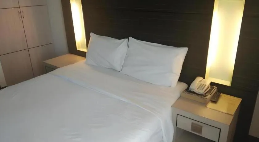 Bed in Grand Medallion Hotel