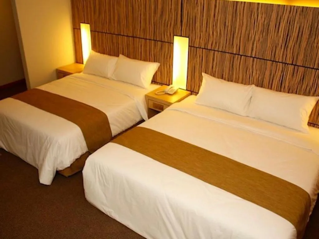 Bed in Grand Medallion Hotel