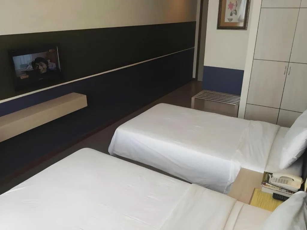 Bed in Grand Medallion Hotel