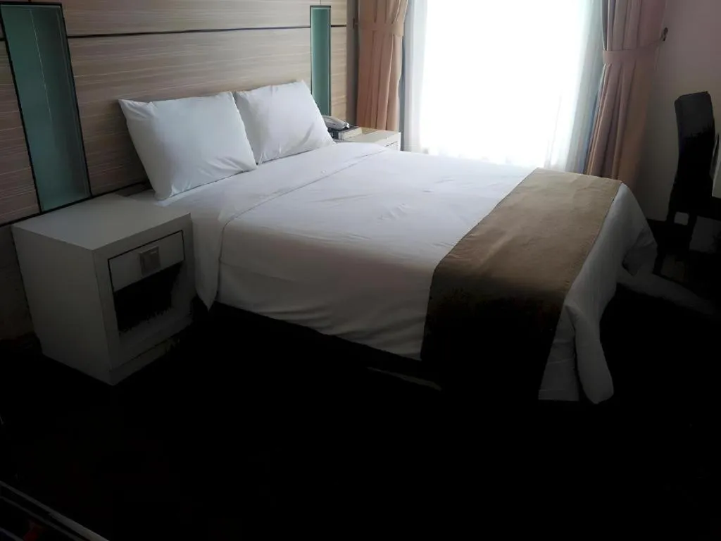 Bed in Grand Medallion Hotel