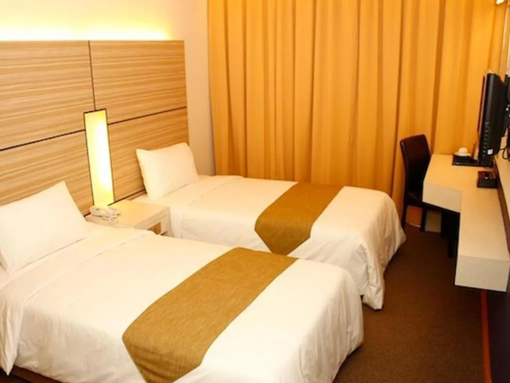 Bed in Grand Medallion Hotel