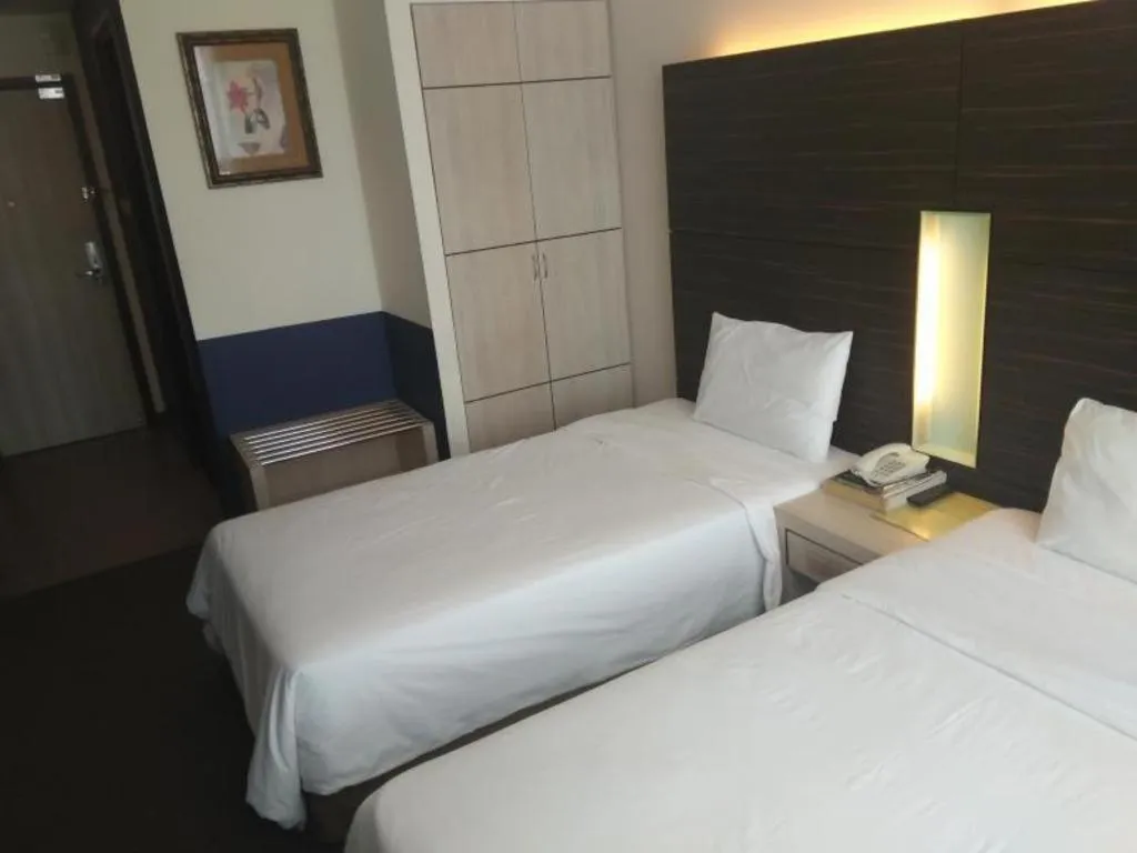 Bed in Grand Medallion Hotel